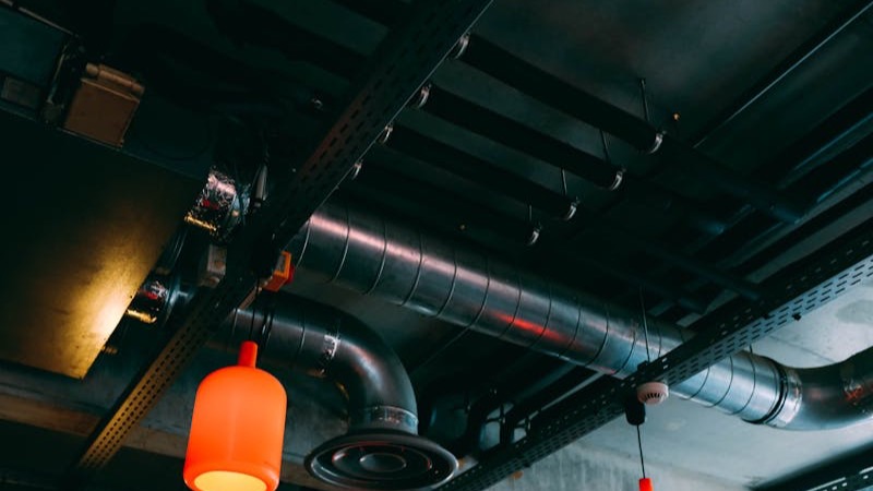 Technician servicing a central ducted AC system in a Qatar building